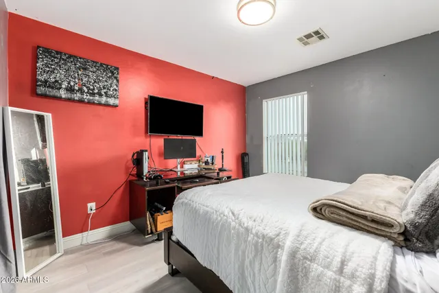 a bedroom with a bed and a window