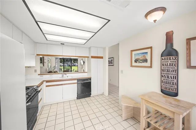 a kitchen with stainless steel appliances kitchen island granite countertop a refrigerator and a stove top oven