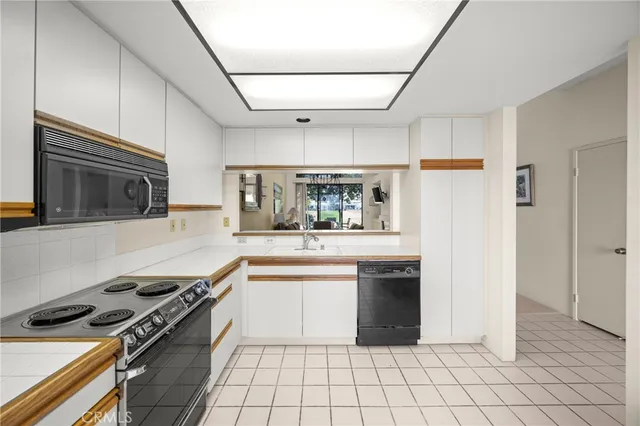 a kitchen with a stove a sink and a refrigerator