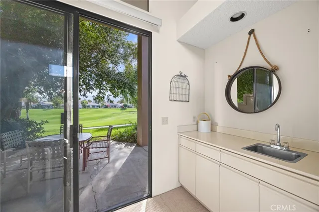 a bathroom with a sink a mirror and next to a window