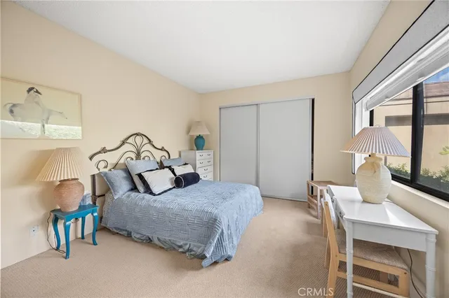 a bedroom with a bed and lamp