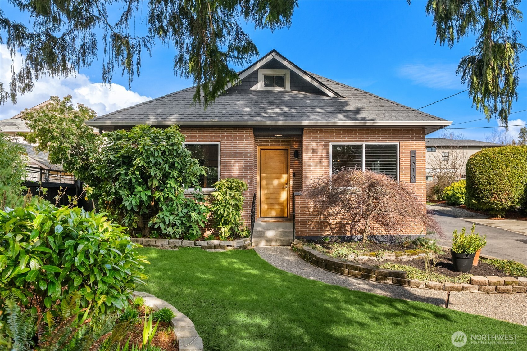 4610 South Holly Street Seattle, WA 98118 - Photo 1 of 27 a front view of a house with a garden