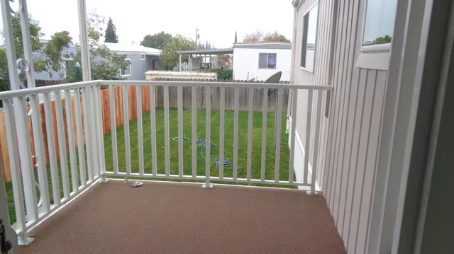 a view of a balcony with wooden floor