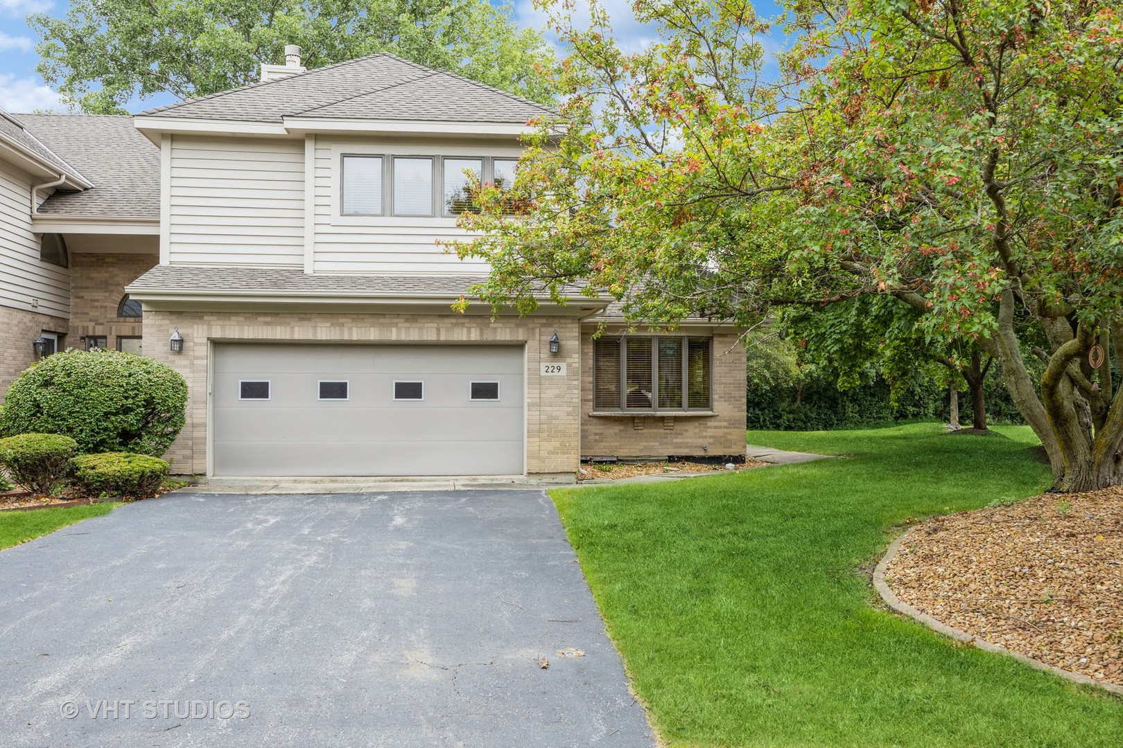 229 Shea Drive Flossmoor, IL 60422 - Photo 1 of 25 a view of a white house next to a yard with big trees