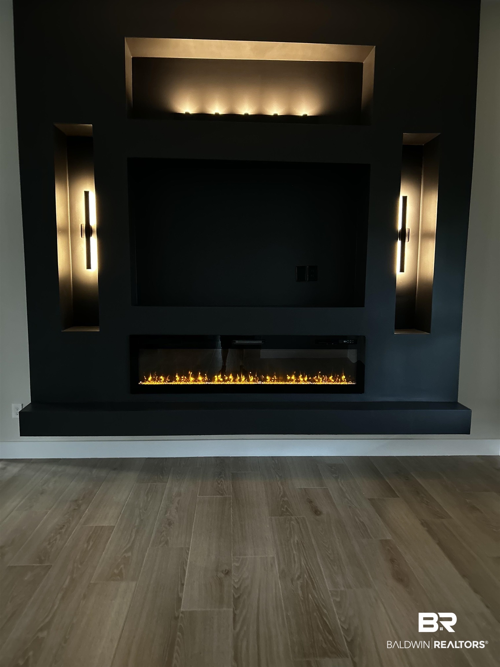 13066 Gopher Court Elberta, AL 36530 - Photo 30 of 38 Integrated media wall featuring an electric fireplace with realistic flame effects, recessed lighting, and stylish accent sconces.
