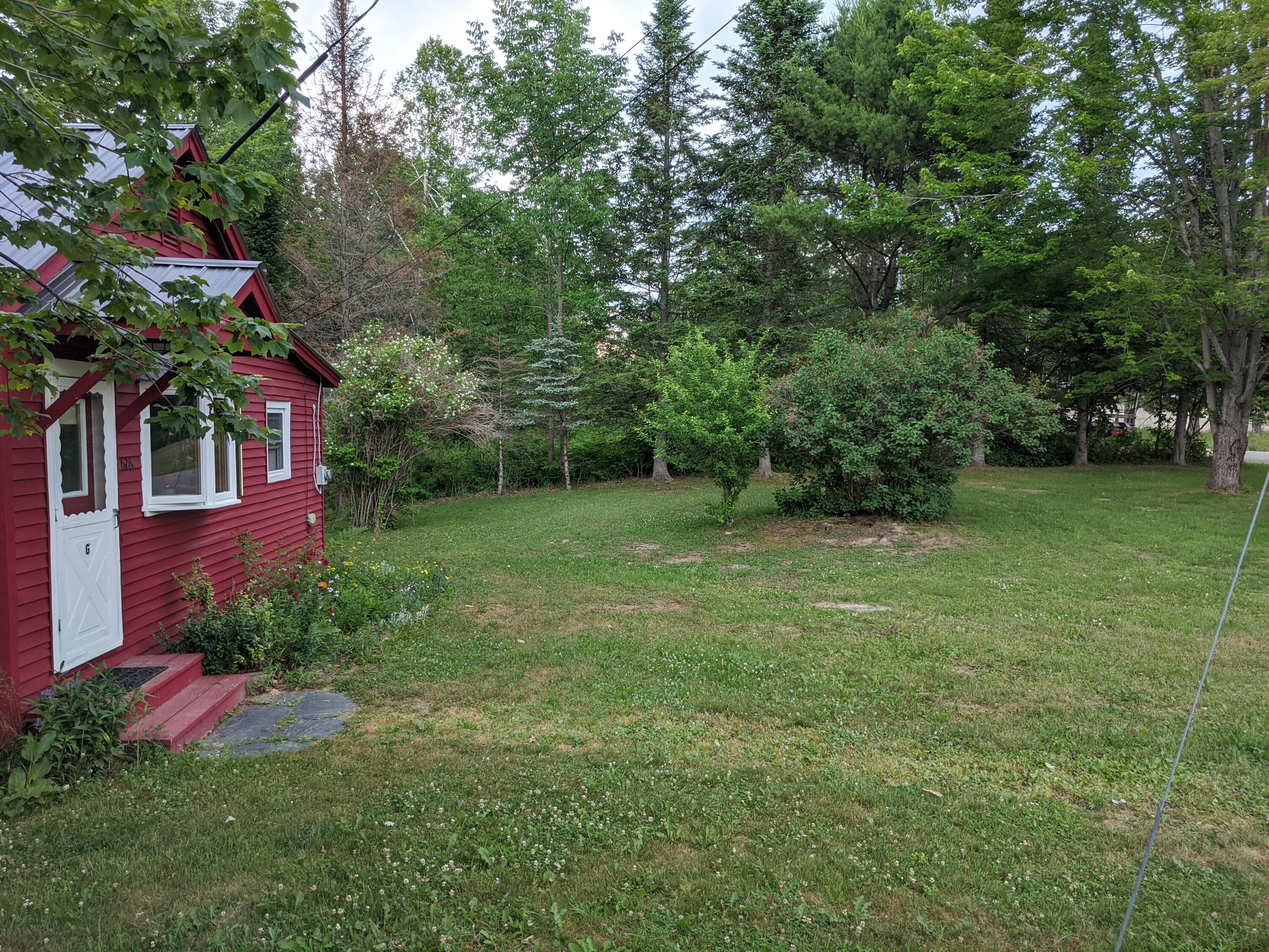 626 Sebec Village Road, Unit G Sebec, ME 04481 - Photo 24 of 27 Lawn with Lillac Bushes