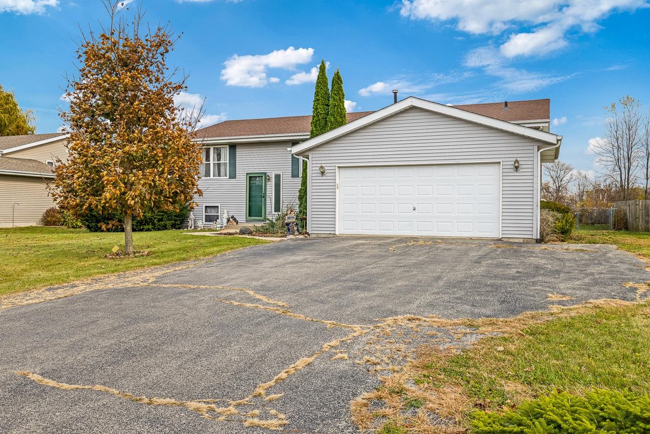 a view of a house with a yard and garage
