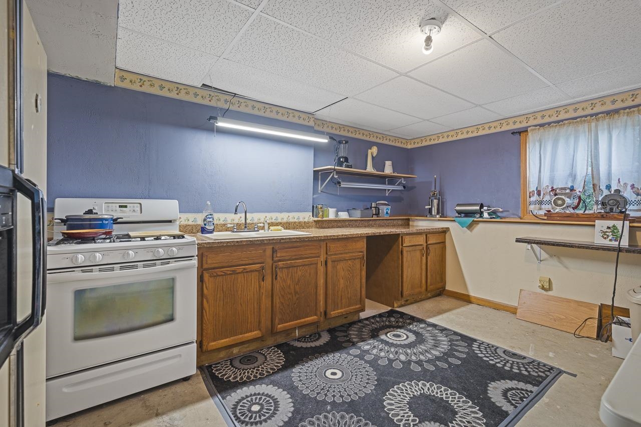 175 Harvest Moon Trail Capron, IL 61012 - Photo 21 of 27 a kitchen with a stove sink and cabinets