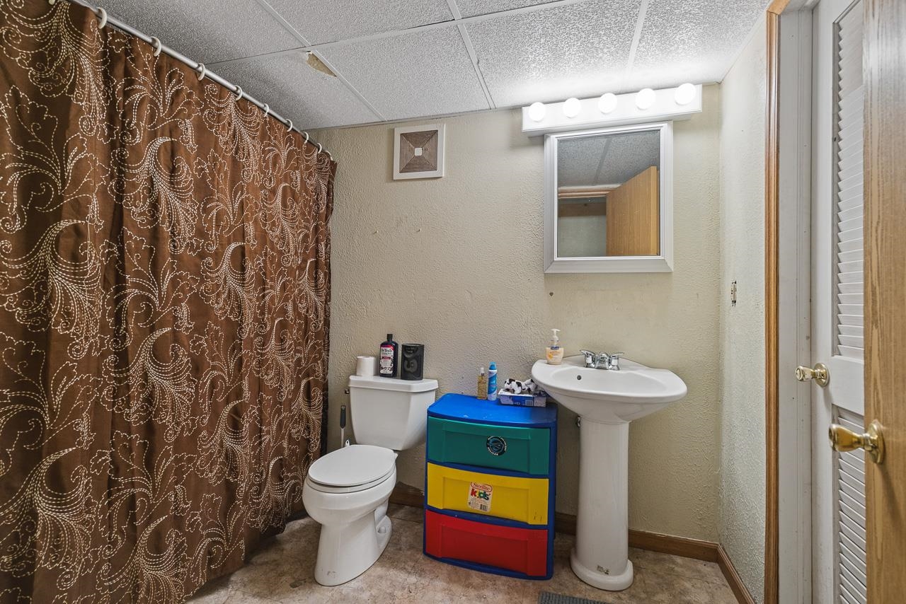 175 Harvest Moon Trail Capron, IL 61012 - Photo 22 of 27 a bathroom with a toilet sink and mirror