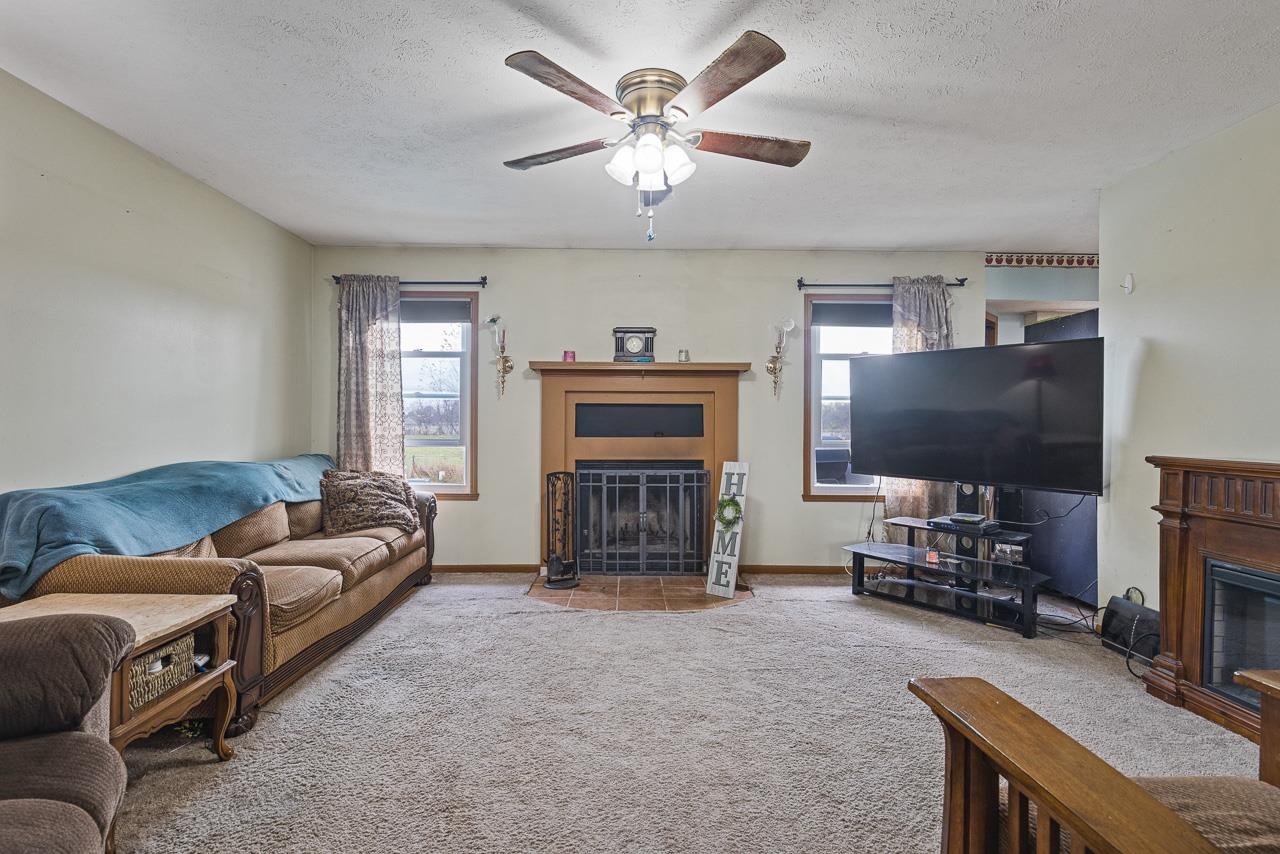 175 Harvest Moon Trail Capron, IL 61012 - Photo 4 of 27 a living room with furniture and a flat screen tv