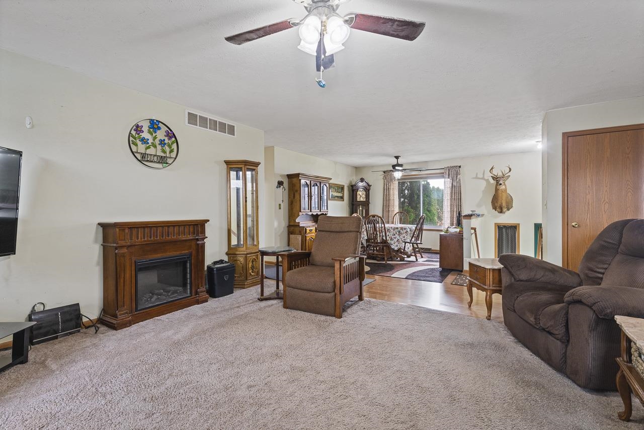 175 Harvest Moon Trail Capron, IL 61012 - Photo 5 of 27 a living room with furniture and a fireplace