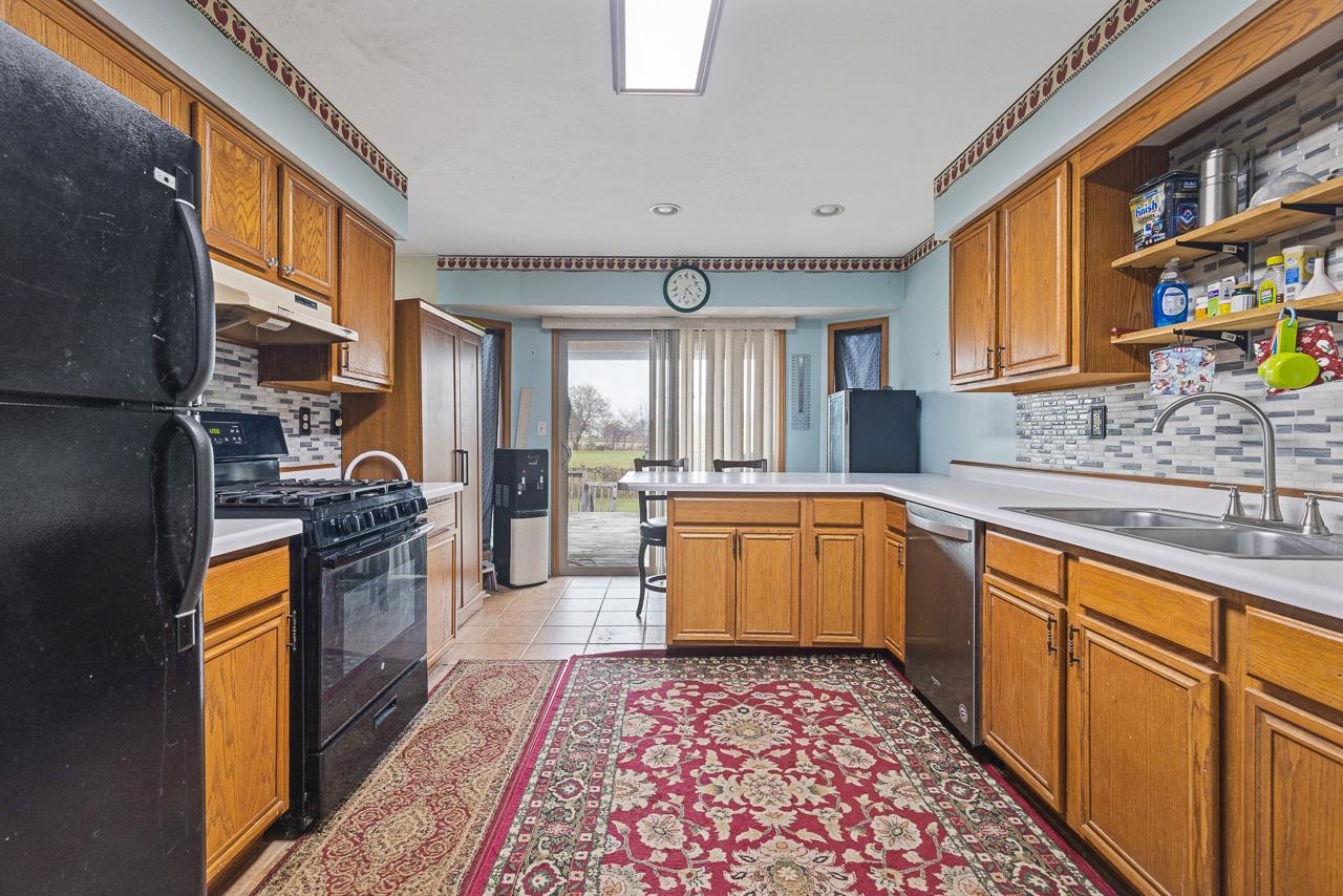 175 Harvest Moon Trail Capron, IL 61012 - Photo 7 of 27 a large kitchen with stainless steel appliances granite countertop a stove a sink dishwasher and cabinets