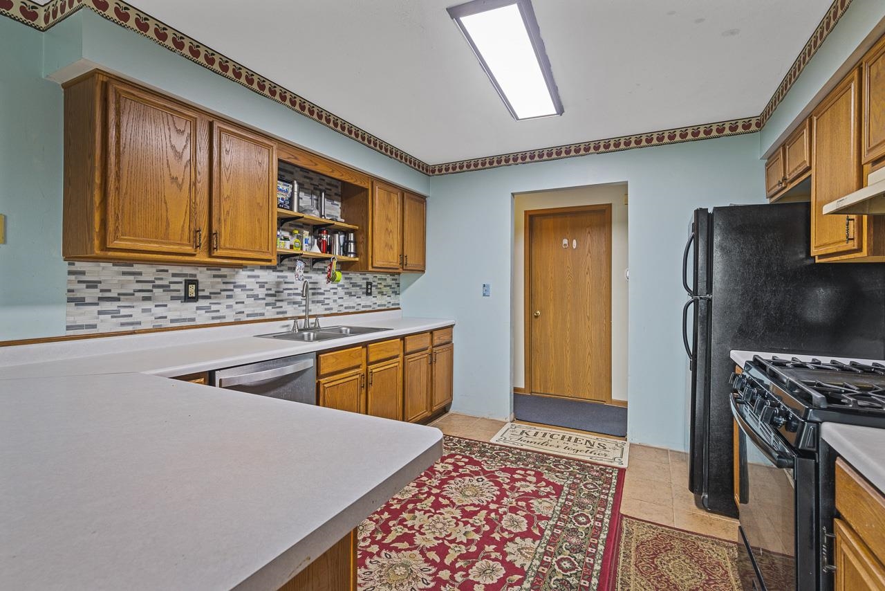 175 Harvest Moon Trail Capron, IL 61012 - Photo 9 of 27 a kitchen with stainless steel appliances granite countertop a refrigerator a stove and a sink