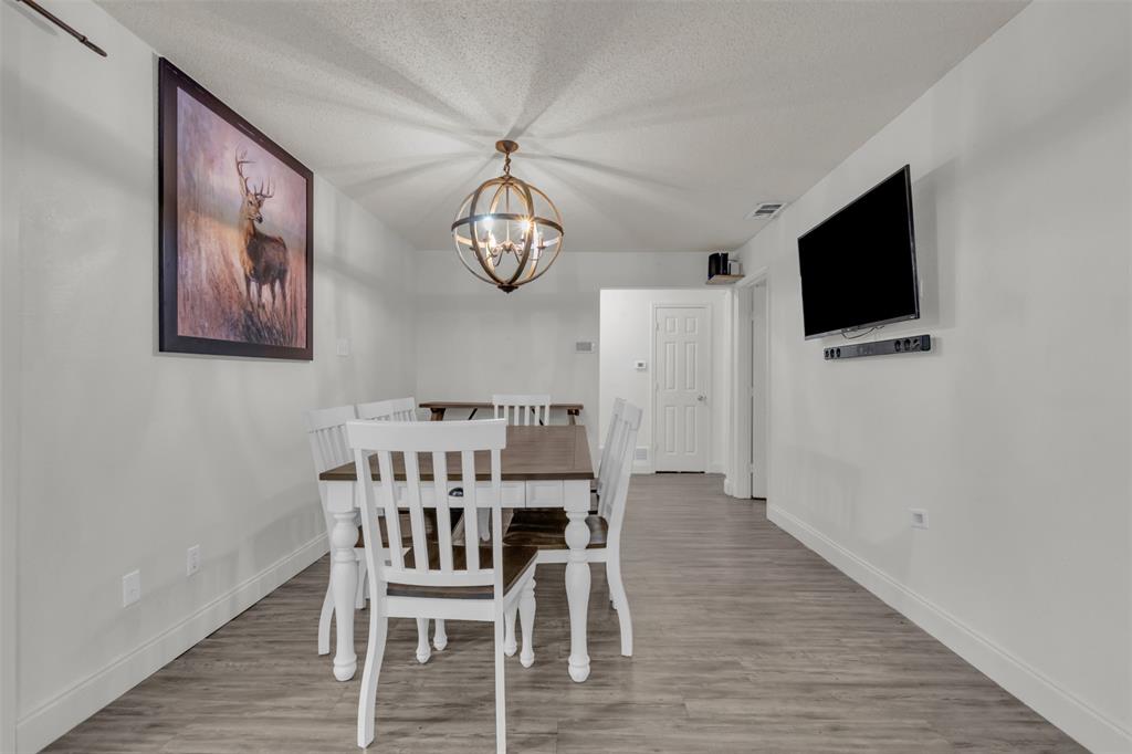 929 North Hall Street Lancaster, TX 75146 - Photo 12 of 24 a view of a dining room with furniture and wooden floor
