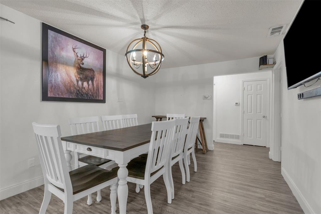 929 North Hall Street Lancaster, TX 75146 - Photo 13 of 24 a view of a dining room with furniture wooden floor and chandelier