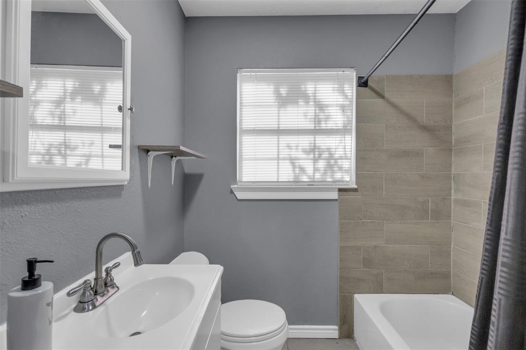 929 North Hall Street Lancaster, TX 75146 - Photo 15 of 24 a bathroom with a sink toilet a mirror and shower