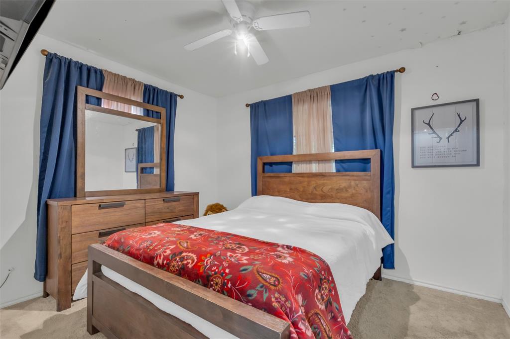 929 North Hall Street Lancaster, TX 75146 - Photo 16 of 24 a bedroom with a bed and a mirror