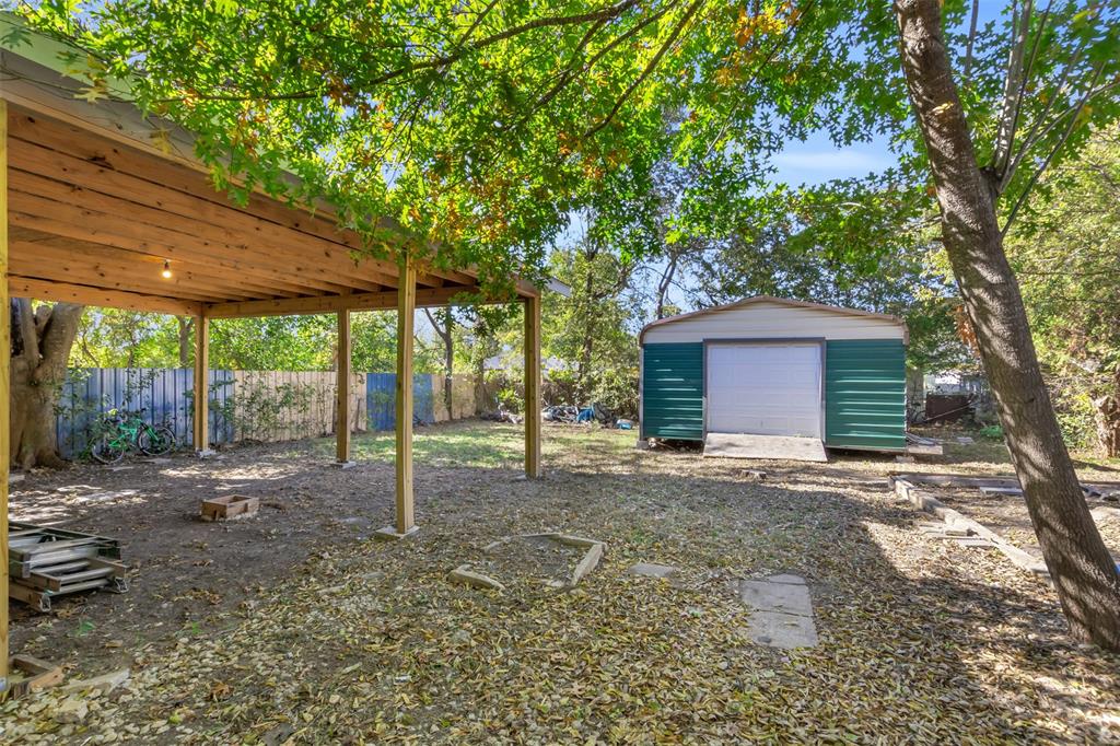 929 North Hall Street Lancaster, TX 75146 - Photo 22 of 24 a house with trees in front of it