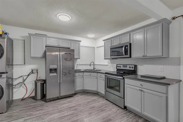 a kitchen with stainless steel appliances a refrigerator stove and microwave