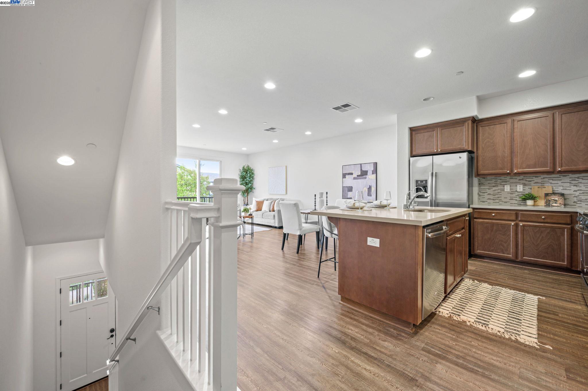 2336 Carbondale Way Dublin, CA 94568 - Photo 12 of 54 a kitchen with stainless steel appliances granite countertop a table chairs sink and cabinets