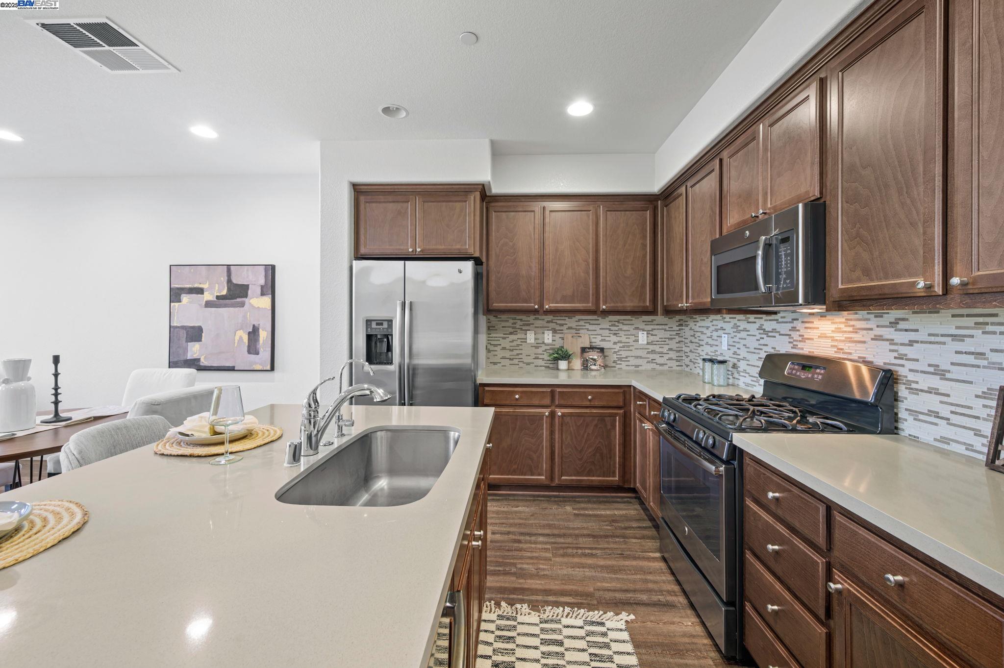 2336 Carbondale Way Dublin, CA 94568 - Photo 16 of 54 a kitchen with stainless steel appliances granite countertop a sink stove and refrigerator