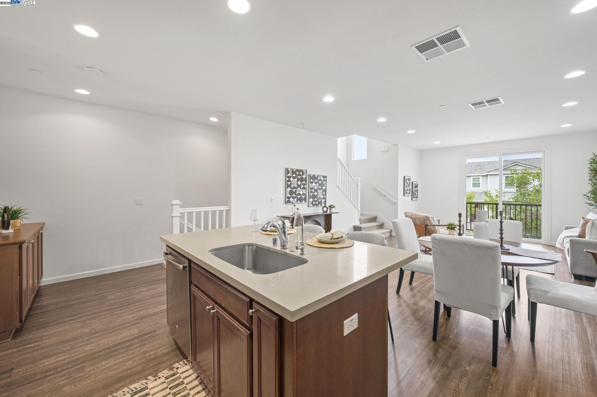 2336 Carbondale Way Dublin, CA 94568 - Photo 18 of 54 a kitchen with a dining table chairs sink and stove