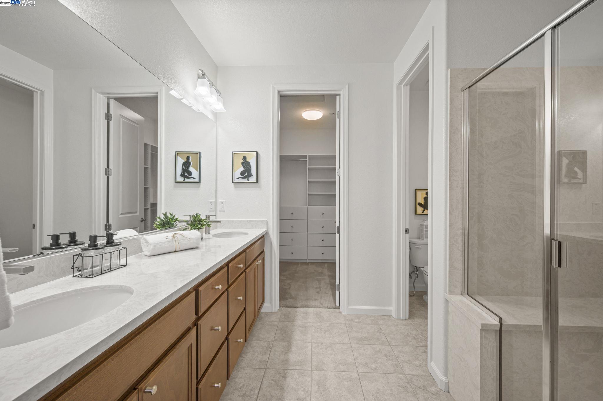 2336 Carbondale Way Dublin, CA 94568 - Photo 40 of 54 a spacious bathroom with a double vanity sink a mirror and a shower