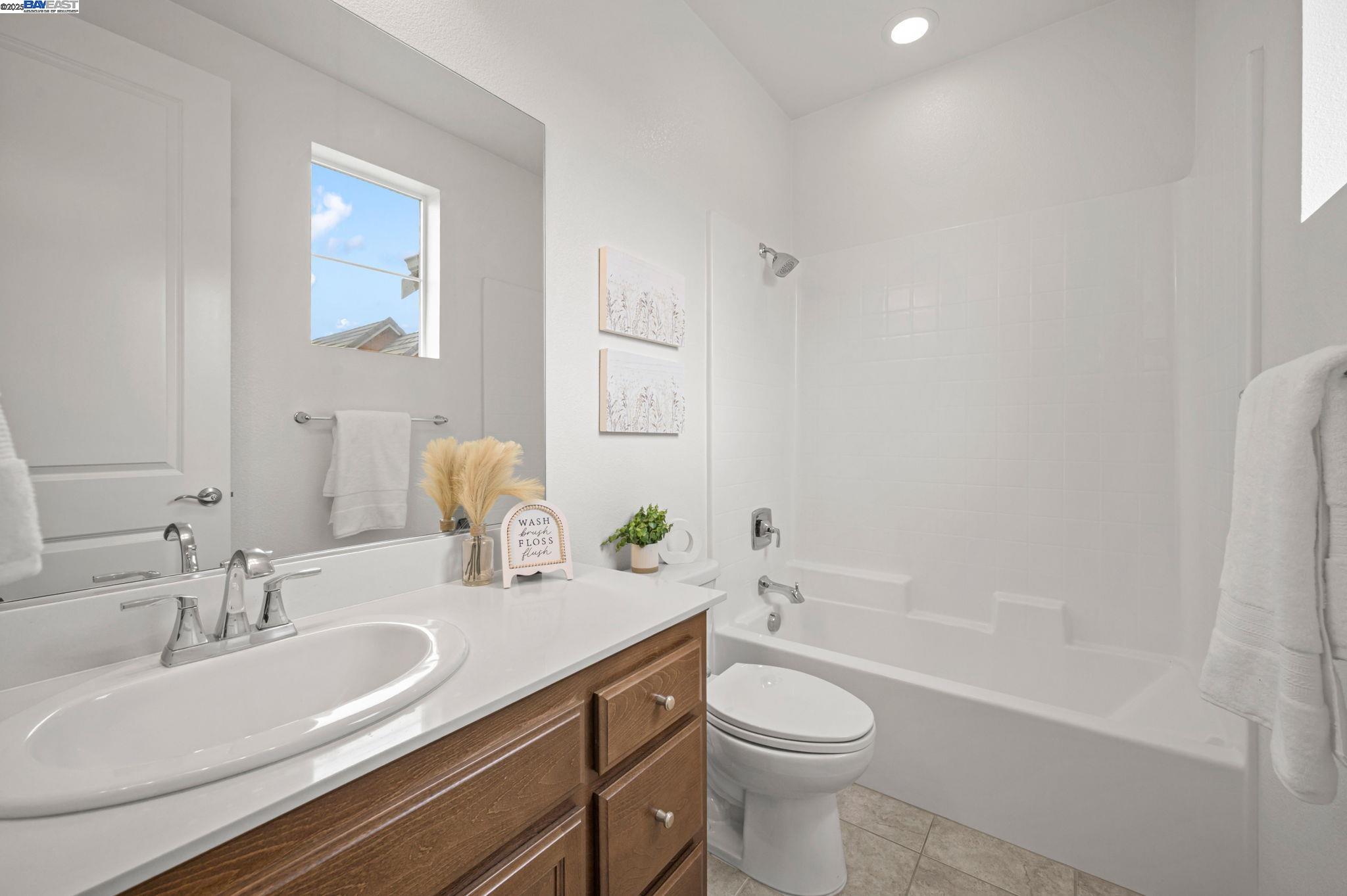 2336 Carbondale Way Dublin, CA 94568 - Photo 46 of 54 a bathroom with a granite countertop sink toilet a large mirror a bathtub and shower