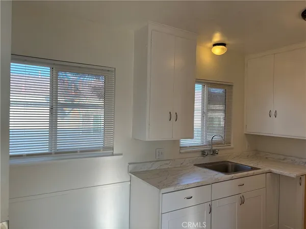 a kitchen with a sink cabinets and window
