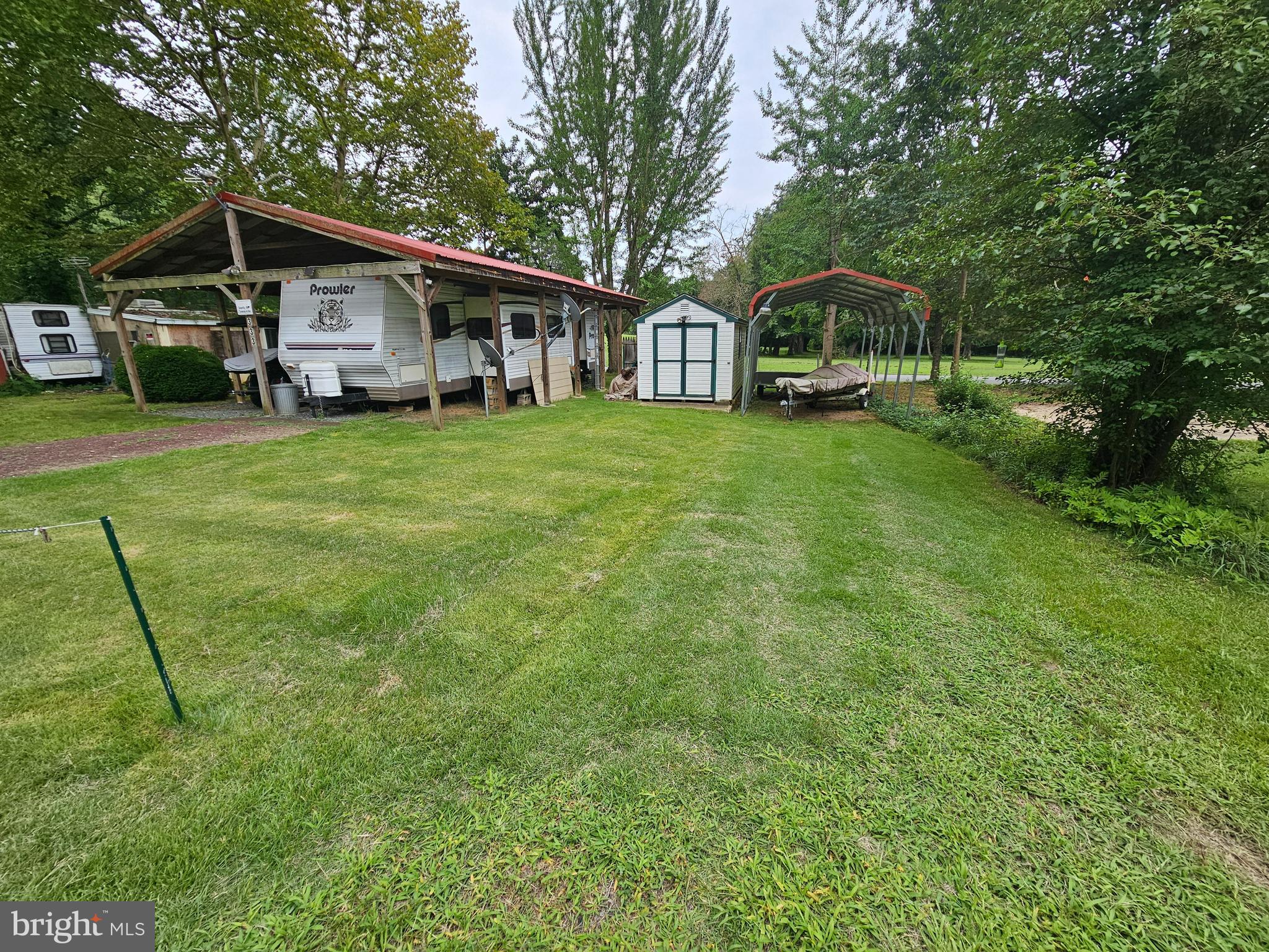 Two lots with camper under roof, shed and carport
