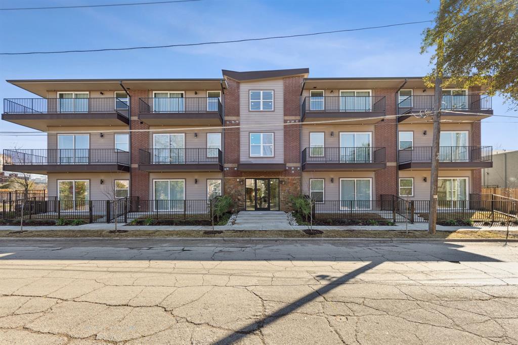 a front view of building with cars parked