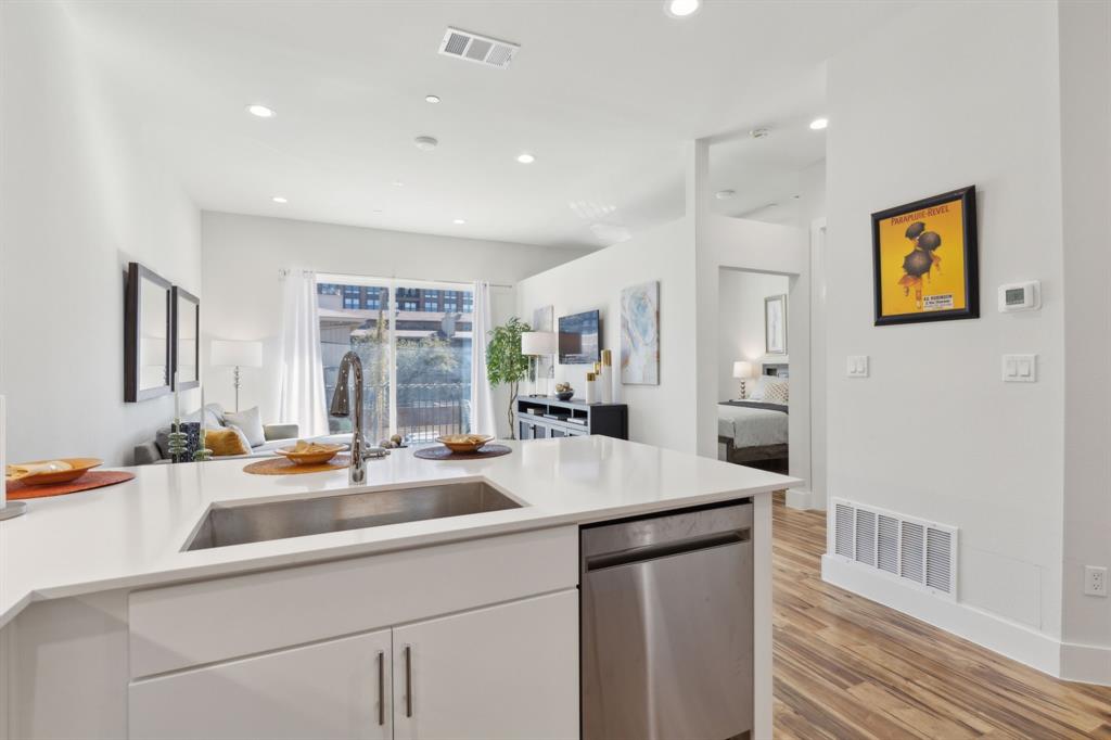 2990 Reagan Street Dallas, TX 75219 - Photo 7 of 20 a kitchen with a sink and a refrigerator