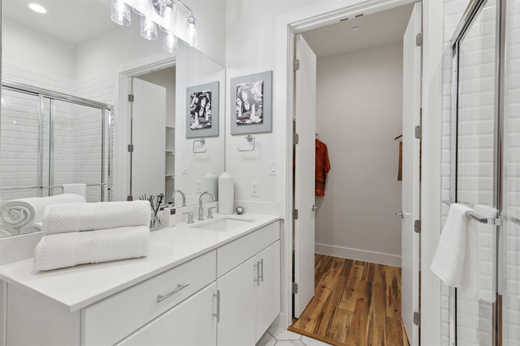 2990 Reagan Street Dallas, TX 75219 - Photo 8 of 20 a en suite bathroom with a double vanity sink a mirror and a shower