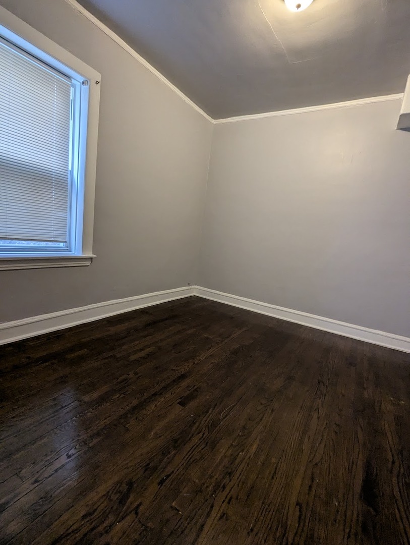 7545 South May Street Chicago, IL 60620 - Photo 18 of 18 a view of a small space with wooden floor and a window