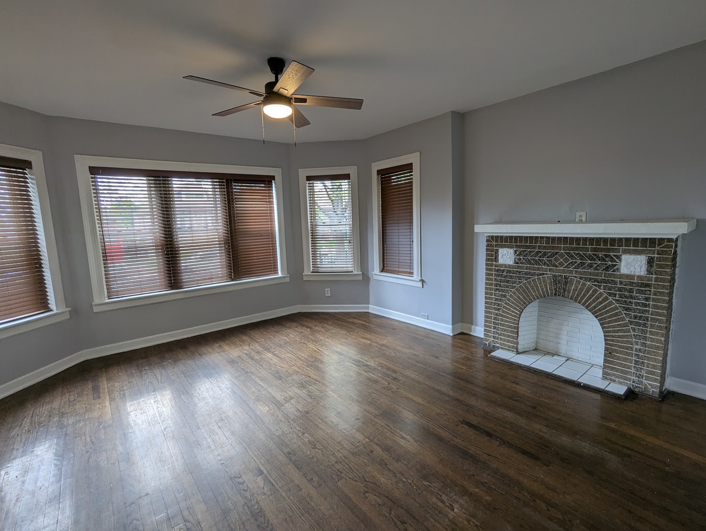 7545 South May Street Chicago, IL 60620 - Photo 2 of 18 a view of an empty room with wooden floor and a window