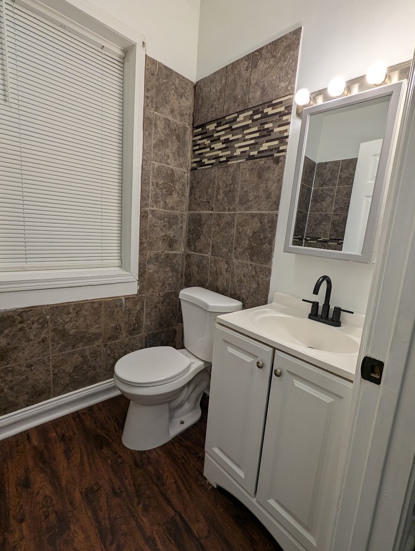 7545 South May Street Chicago, IL 60620 - Photo 5 of 18 a bathroom with a sink and a toilet