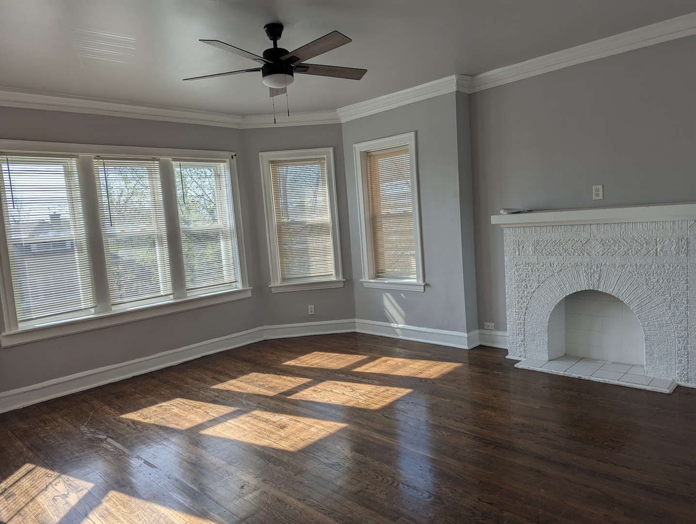 7545 South May Street Chicago, IL 60620 - Photo 6 of 18 a view of empty room with wooden floor and fan