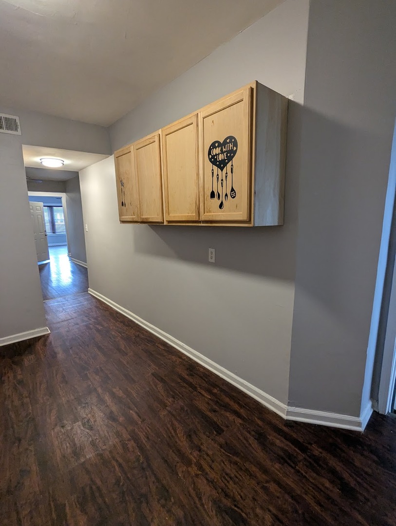 7545 South May Street Chicago, IL 60620 - Photo 10 of 18 a view of a hallway with wooden floor