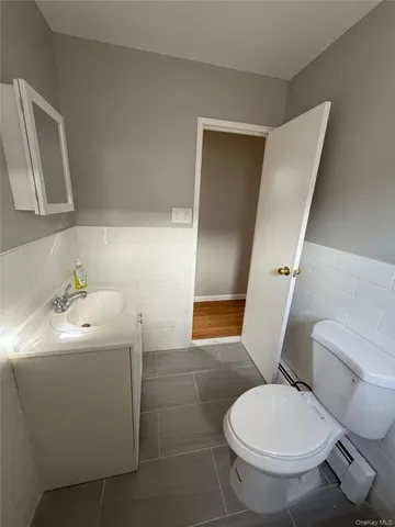 a white toilet sitting next to a bathroom sink