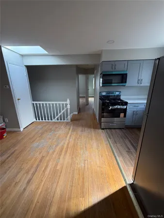 a view of kitchen with sink and microwave