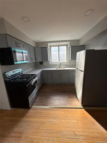 a kitchen with stainless steel appliances granite countertop a stove and a refrigerator