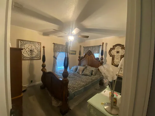 a living room with furniture and a painting on the wall