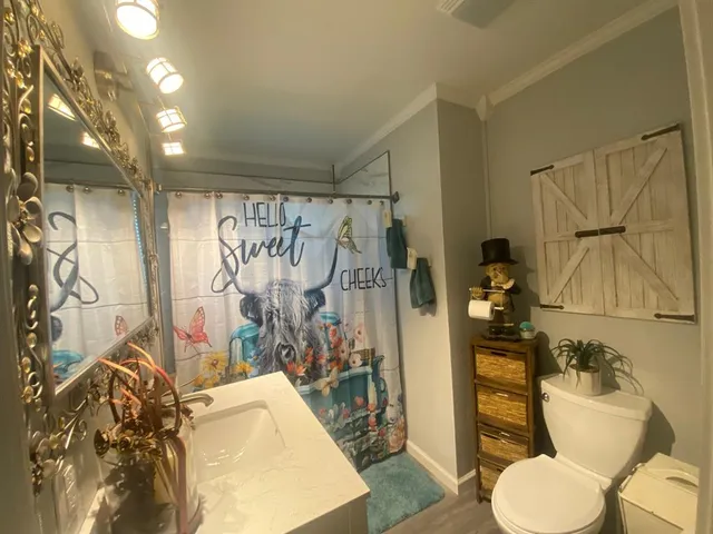 a bathroom with a toilet sink and shower