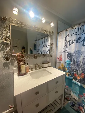 a bathroom with a sink double vanity and a mirror
