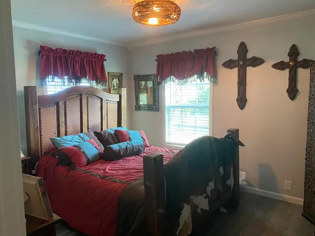 a bed sitting in a bedroom next to a window