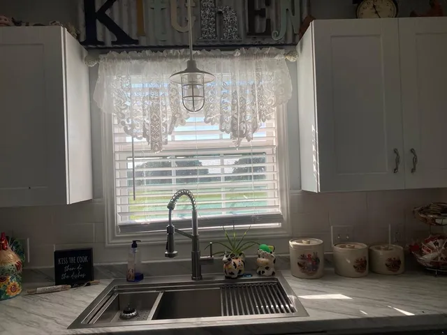 a kitchen with a sink and a window