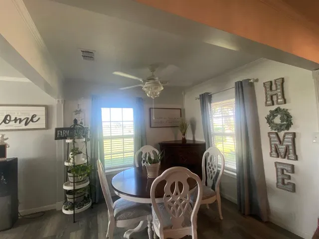 a dining room with furniture and window