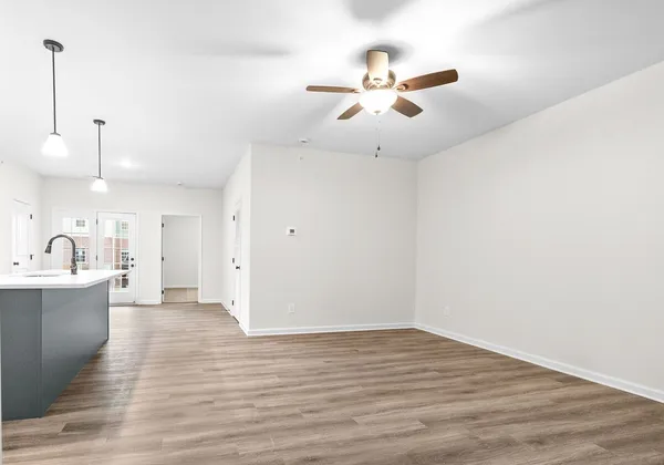 a view of a kitchen with a sink and wooden floor