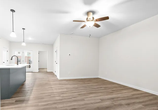 a view of a kitchen with a sink and wooden floor