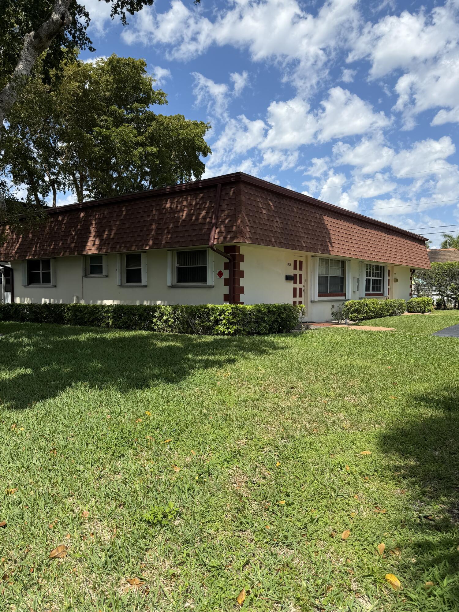 3225 Northeast 21st Avenue, Unit 7 Lighthouse Point, FL 33064 - Photo 1 of 28 a front view of house with yard and green space